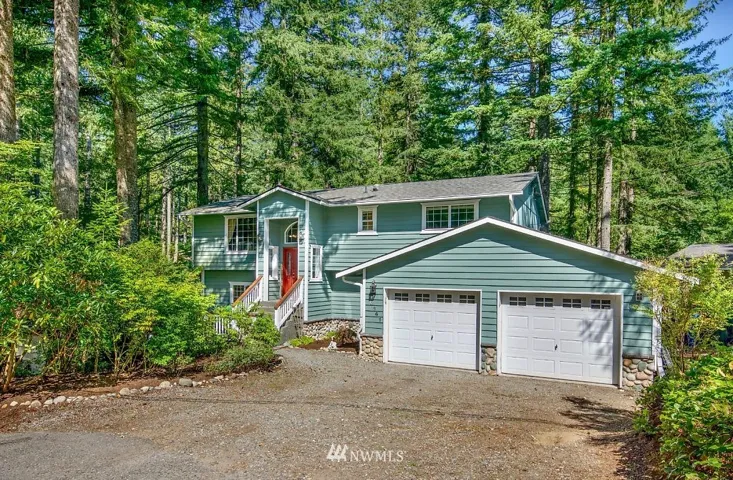 Cedar siding and stone on this large Winderness Rim home on quiet street.