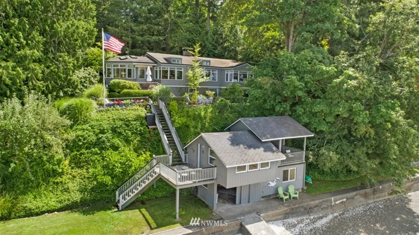 Welcome to 309 39th Ave NE. This lovely waterfront home is located just 7 minutes from Downtown Olympia. 135' of west facing Puget Sound waterfront.  This photos gives you the perfect perspective of the property. The two story boat house has a living space, 3/4 bath, covered deck and a large storage area on the ground floor.  The Boat house is considered the ADU per County records.