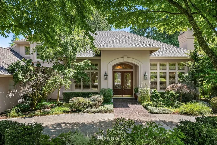 Tucked at the end of a beautiful cul de sac...an elegant circle driveway greets you. Garages are along the side of the home, as is a hidden "boat house."