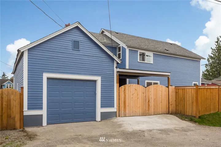 Great home with garage off alley and carport.