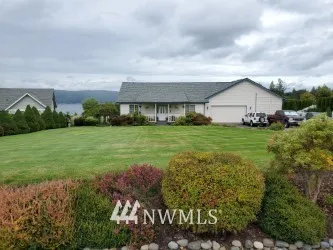 This lovely home sits on top of the world in a small gated community. It features spectacular Hood Canal and Olympic Mountain views