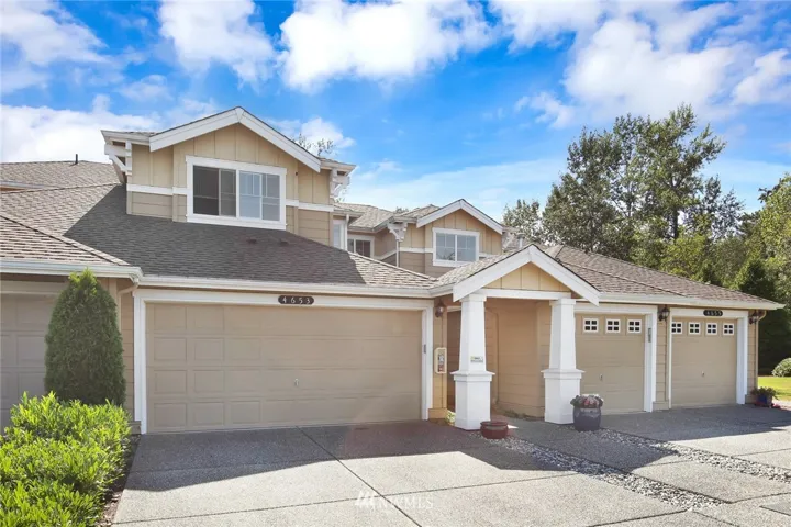 Double car garage featuring large level driveway that is bigger than the other units in the complex