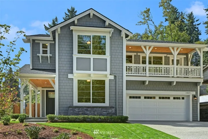 Inviting Ballard plan with covered entry and charming deck over the garage
