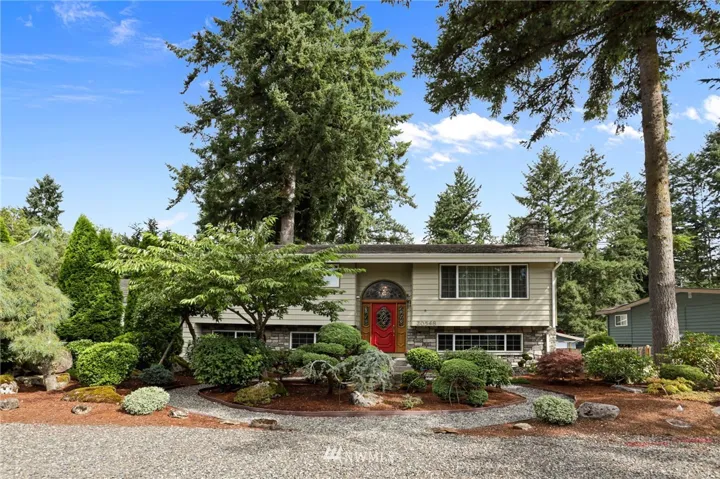 Front of this beautiful home, fully landscaped with mature plants and trees.