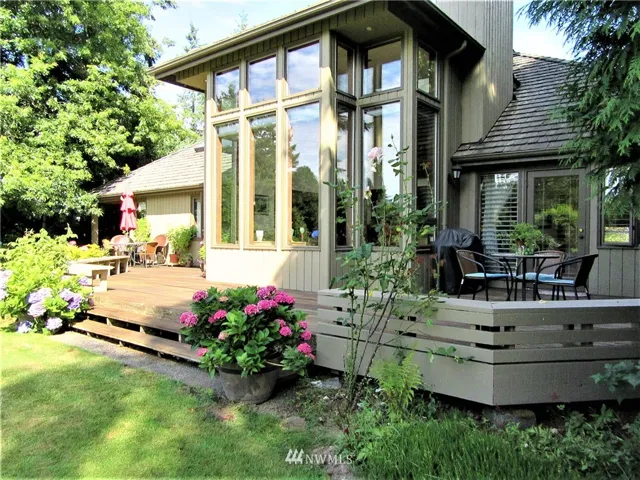 Golf course living on 13th Fairway!  Gorgeous Landscaping, wrap around deck and Window Wall for beautiful views of golf course and outdoor living.