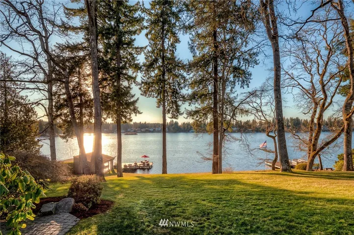 Western exposure affords incredible sunsets of the sunlight dancing on the water on this .76 acre Lake Steilacoom estate.