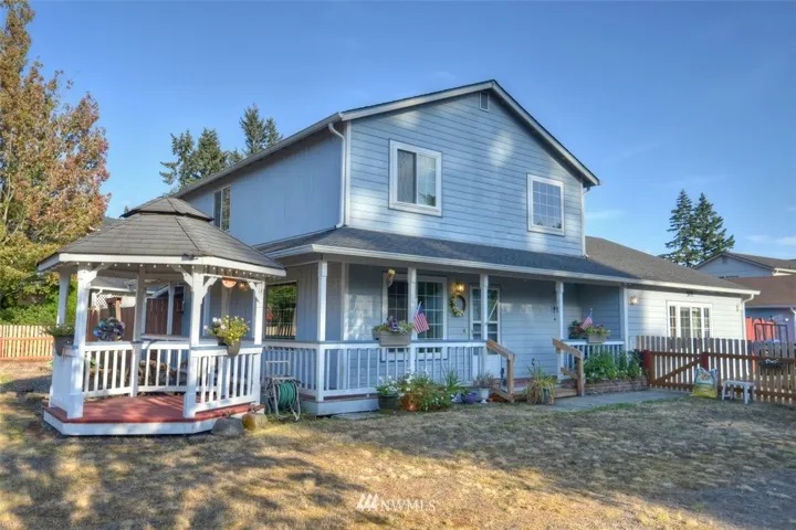 Covered porch wraps the north and west sides of the home. Enjoy a refreshing beverage in your gazebo as you watch the sun set.