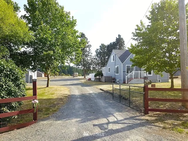 Enter through the gate into a unique 5ac property which incudes a  beautiful country farm house,5 car garage & shop plus a barn on 5 ac.