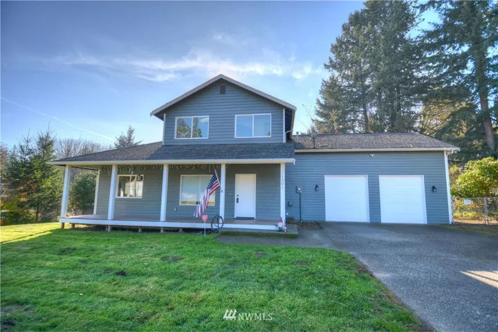 Large Covered Porch and Oversized Garage and Doors for possible Commercial vehicles, Room for RV or Boat behind gate side of house and lots of parking on driveway and to the right side on gravel full length of driveway