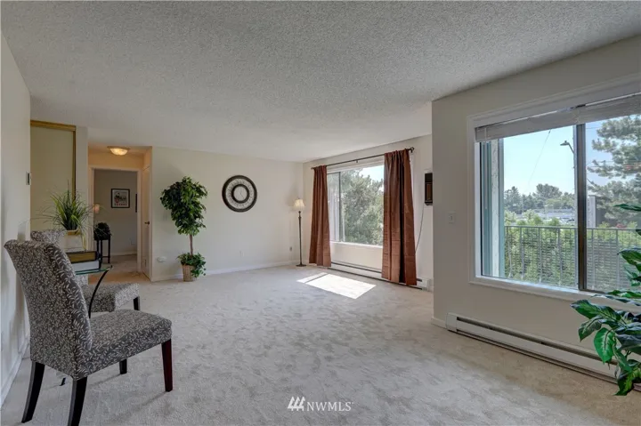 Over-sized living room with built in A/C, new blinds, new curtains, new paint, new carpeting and new molding.