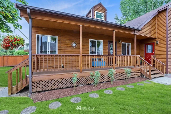 Charming front porch...spend a quiet evening here, watching the sun set! Think rocking chair or a little table and chairs. Porch swing?