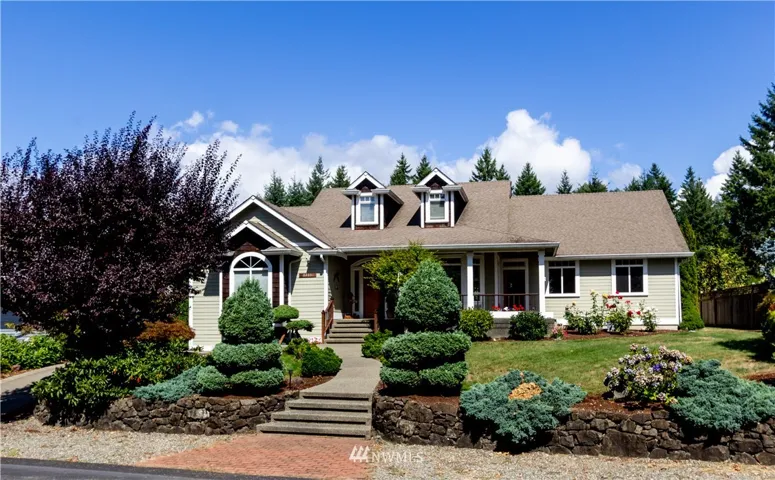 Side walk entry from paved street.  Driveway on left leading  to large 2 car attached garage in private back yard. Rose gardens front and back.
