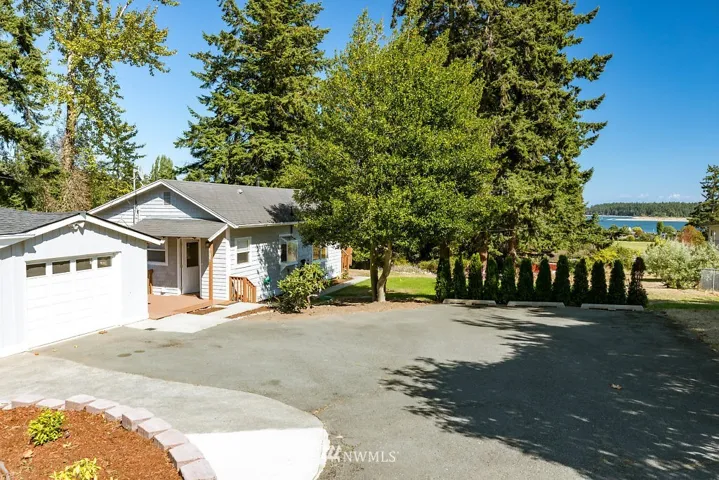 Just under half acre sits this adorable cottage with a view of the harbor.
