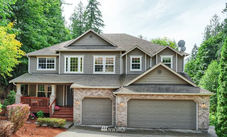 Northwest Traditional architecture - optimally situated on this 1.3 +/- acre lot with large level area for entertaining and events on the East Lawn, to the South a Private backyard with play cottage/shed and outdoor living space, and separate entrance to the guest quarters on the West.