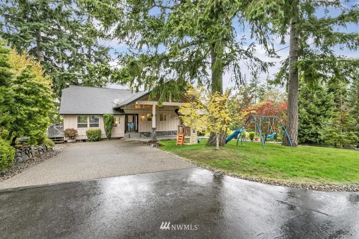 Large circular driveway in front of home, plenty of extra parking and 2 car garage on the side and lower level of the home so bring all your cars, boats, RV's, there is plenty of room!