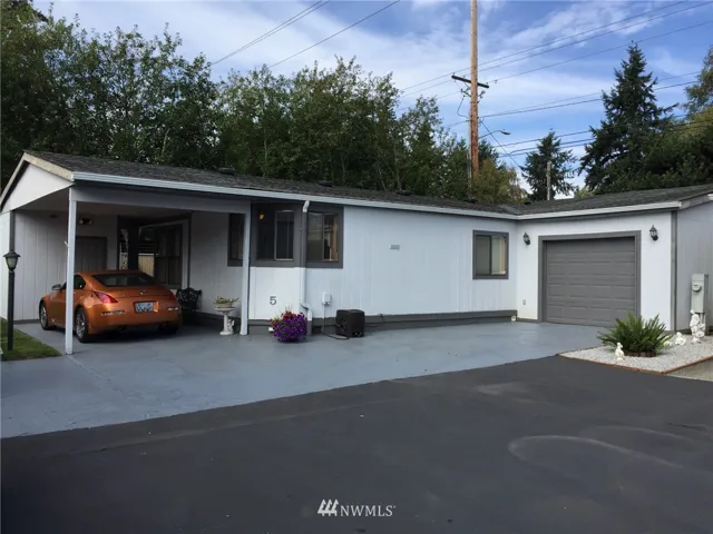 This home features a large garage, carport and additional parking space.