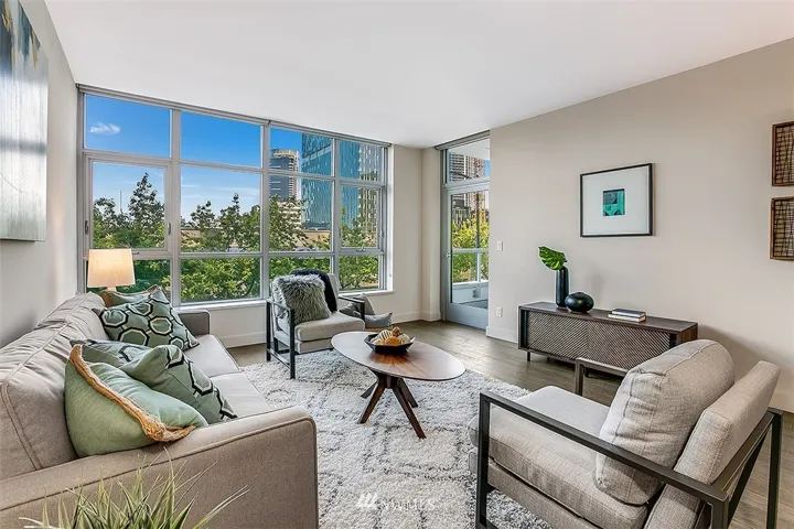 Stunning walls-of-glass in the living room highlight the city scape and trees below.