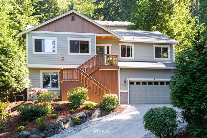 Long flat driveway leading up to the home. Home tucked away from road