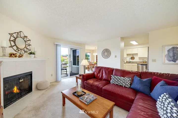 This condo really lives large. Spacious living room with tiled fireplace opens onto covered deck with storage closet. Open floor plan throughout allows for good flow when entertaining.