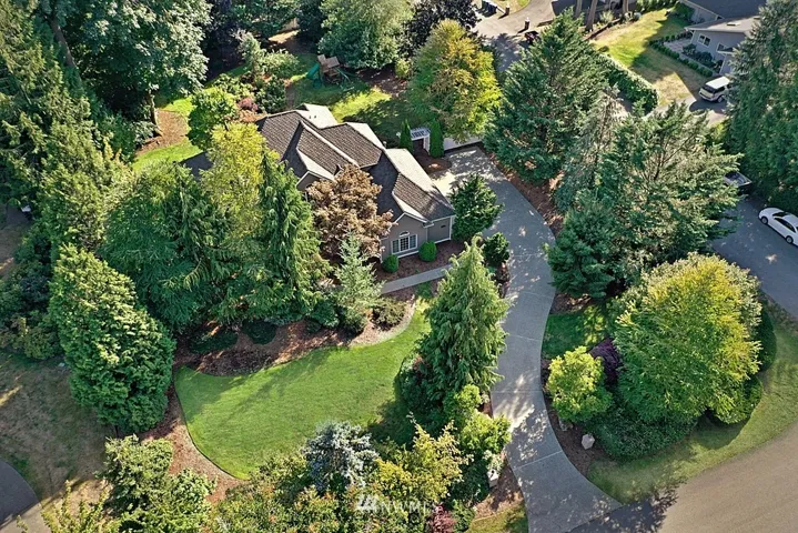 Grand driveway to side 3 car garage with high ceiling. Fenced backyard and sprinkler system.