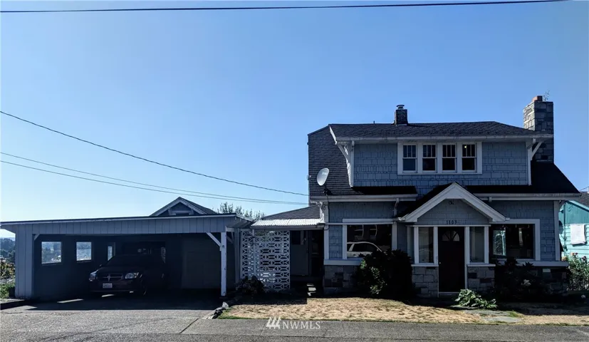 Front of home, and carport with extra storage areas behind