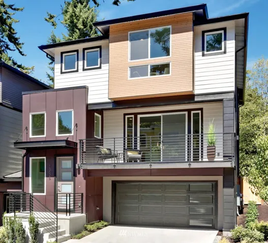 Modern NW Architecture featuring James Hardie fiber cement siding, cedar accents, black metal railing, big deck off living area, 8' entry door with frosted glass, garage door with vertical glass panels and LOTS of windows! Photo is of another home of same floorplan.  Furniture and decorator items not included.   Location, colors and finishes vary and are for reference only.