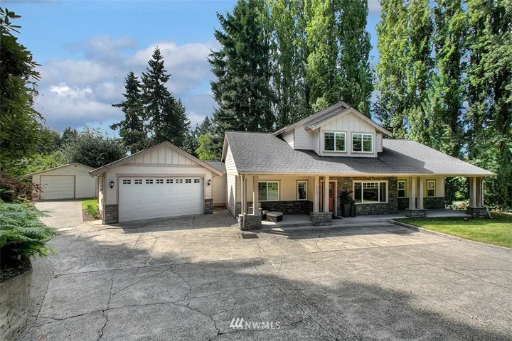 Normandy Park home built with privacy and entertaining in mind.  Front covered porch spans the length of the home with a lovely wood accent door.  Ample parking for guests, your RV or boat.  Two car garage attached and an additional 1+ car and shop detached.