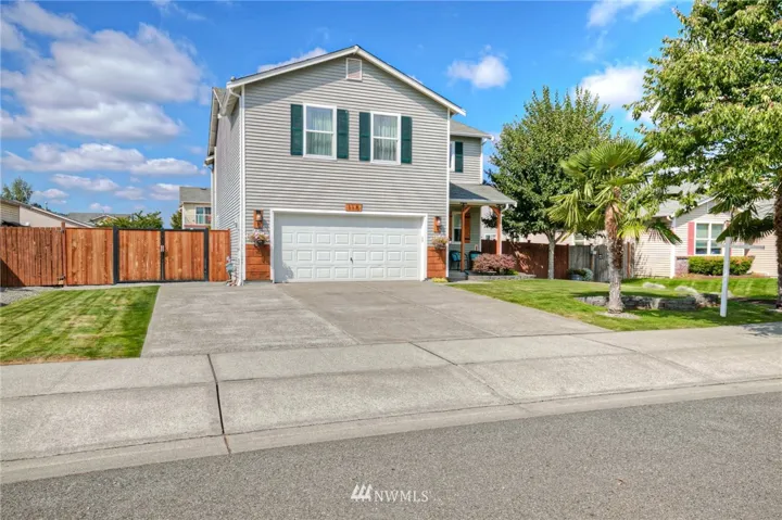 Nicely landscaped yard designed for easy maintenance. Room for RV parking through the gate on the right.