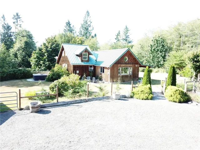 A great place to relax and count the stars!  Beyond the new hot tub is a hill leading down to the creek. This home is located just a stones throw from Crescent Lake and the Strait...or take the ferry ride to nearby Canada!  Make this your vacation home or year round living.  Great neighbors that look after one another and are friendly!  Plenty of outbuildings for all your toys!  The adjoining creek is a great place to cool off as you relax on your own private beach.