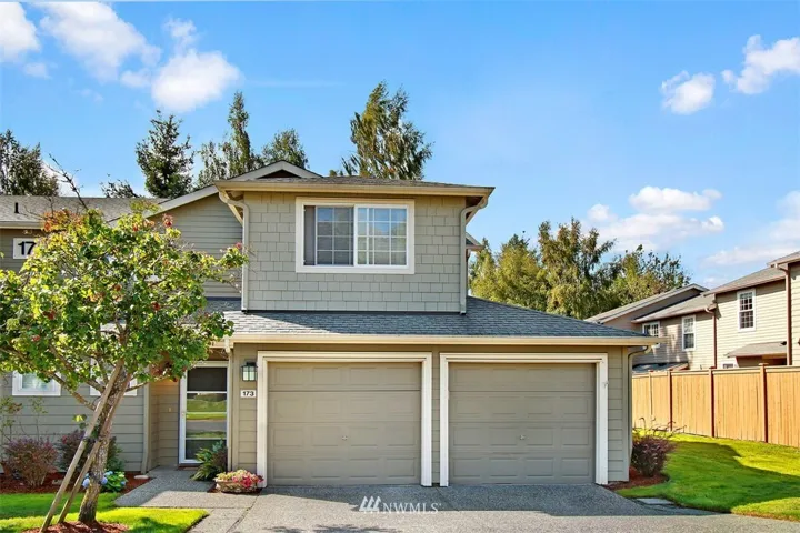 This lovely 2-story townhouse has a two car garage, plus a driveway and fenced backyard.