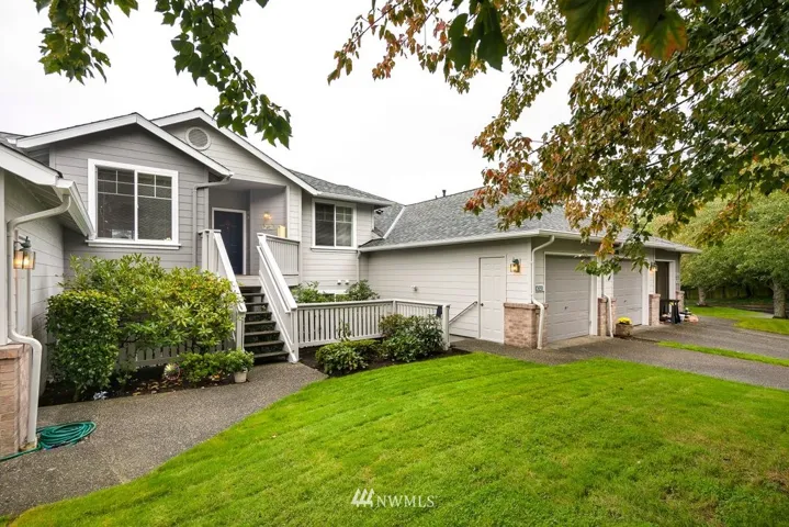 #102 is the ground floor unit. Note the side door entrance to the one-car garage with driveway parking in front. Across the street (not shown) are three spaces for guest parking.