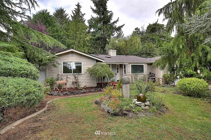 Front yard with mature landscaping that provides privacy.