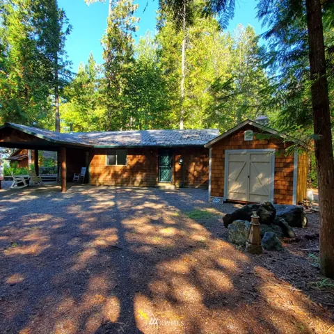 Entry to living area is under carport.  Second door to utility room.  Both have Mascotte Security Doors.  Shed has two doors and a golf cart that comes with the house.