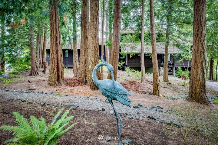 Welcome to 15039 Henderson Road NE, a very cool Mid-Century home, architecturally designed by Gene Zema, and perfectly nestled on a one-acre lush and private setting.