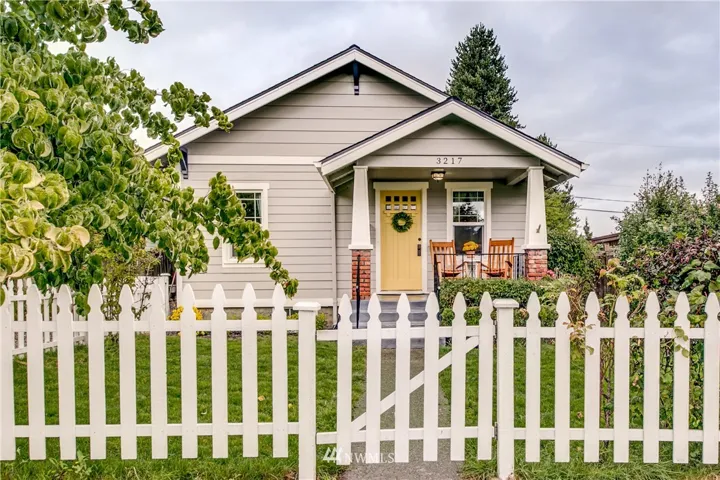Charming Craftsman style home with white picket fence! Lovely!