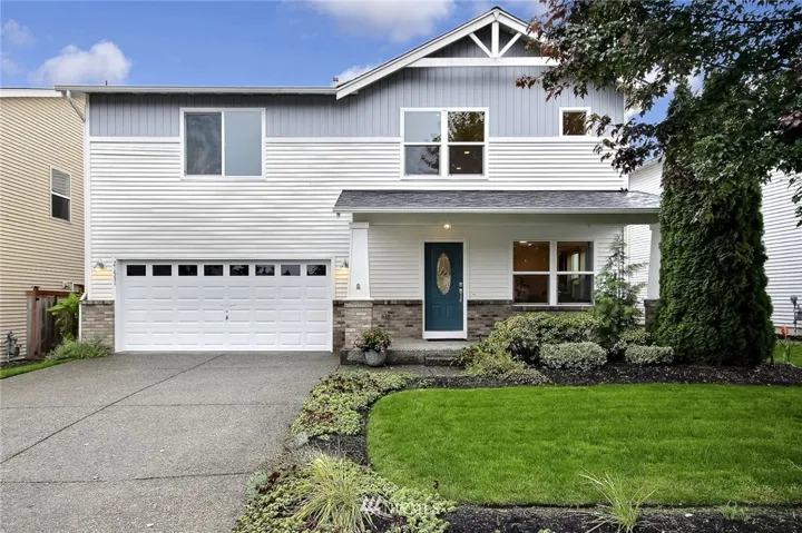 NEW Roof, Long Driveway, Big front porch and manicured landscaping.