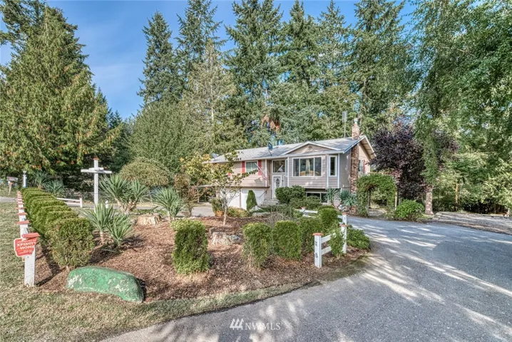 Tucked off the main road, this large circular driveway and tall trees welcome you home!