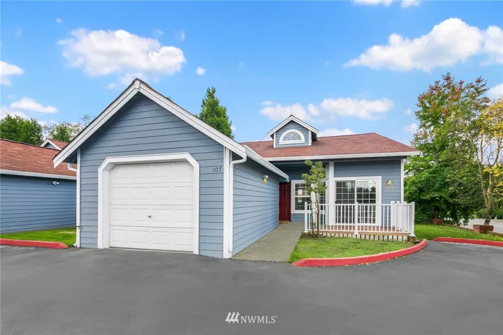Unit A-107 is an end unit. Not only does it  have its own attached garage, but there are also Visitor Parking spaces in front of this row of townhomes.