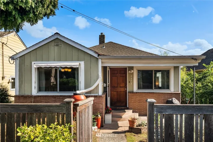 Super cute bungalow with covered porch and private patio space ot the left