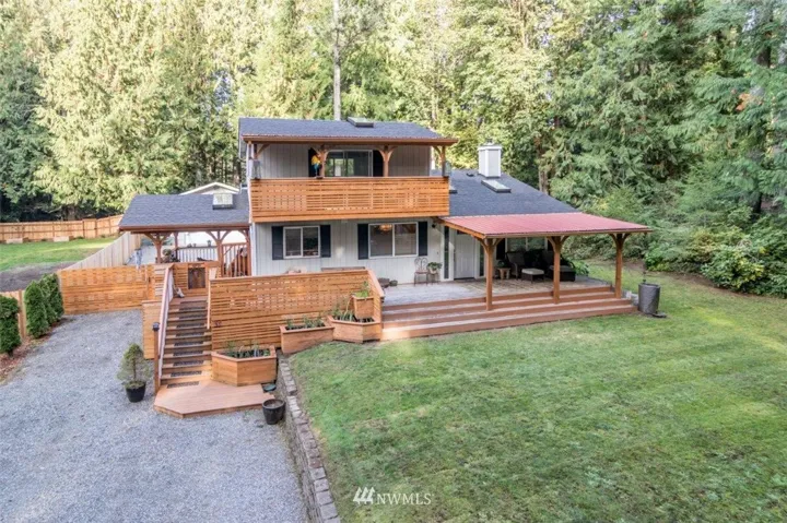 Striking wood work on the front of the house gives it a more contemporary look! Gates & Side fronts of fence match - Gates on both sides of the house
