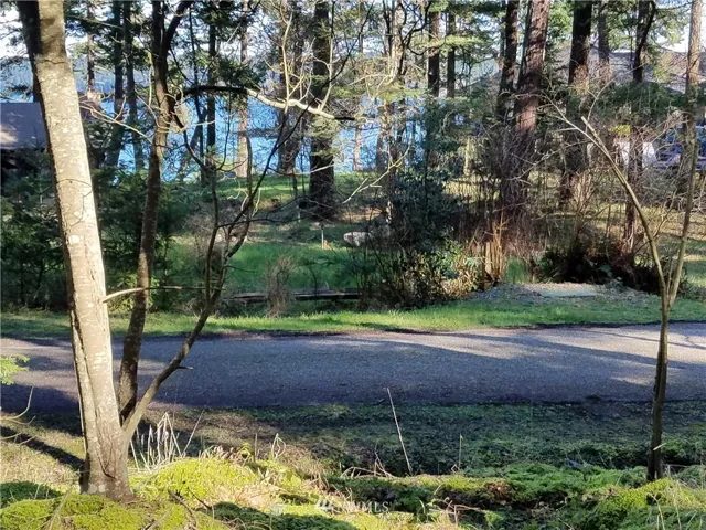 This Cape San Juan homesite is across the street from waterfront homes and enjoys a filtered water view of Cattle Pass with Lopez Island in the distance.