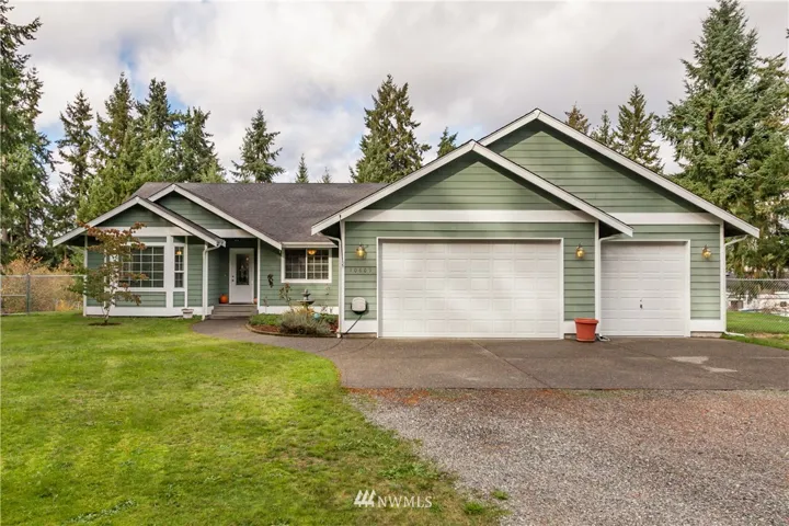 Welcome to one-level living with an oversized three-car garage + shop space!