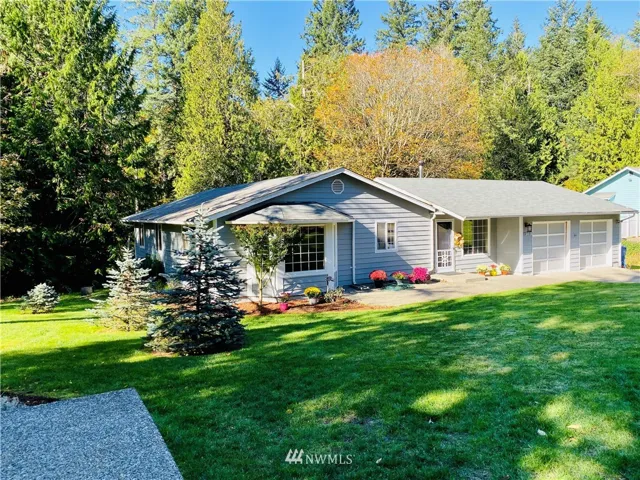 Front view of home. Mature lush landscaping.