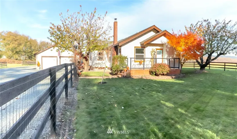 Stunning homestead property on 5 flat acrees. Features freshly painted black fencing with wire interior.  Driveway with new gravel extending around garage to carport. Plenty of room for all the toys and RV!