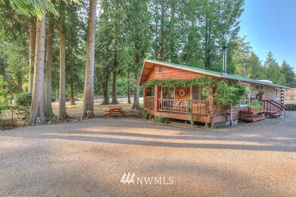 1992 Timberland home is tucked in among mature cedars.