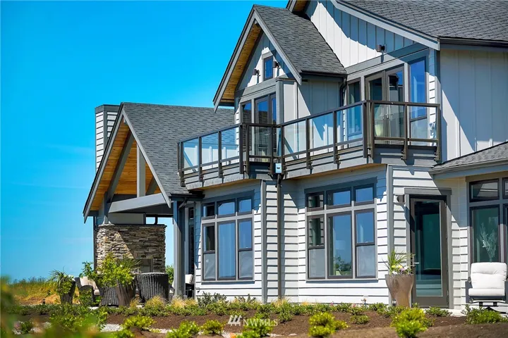 Expansive waterfront home featuring dual master bedrooms, den, butler's pantry, outdoor fireplace, and vaulted ceilings. Located along Semiahmoo Spit.