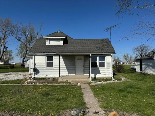 Bungalow-style house featuring roof with shingles and a front yard