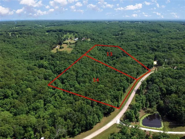 View of property location featuring a forest and property parcel outlined