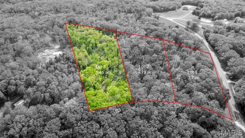 Aerial overview of property's location with property boundaries highlighted and a heavily wooded area