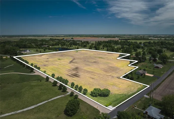 Aerial view of sparsely populated area featuring property parcel outlined